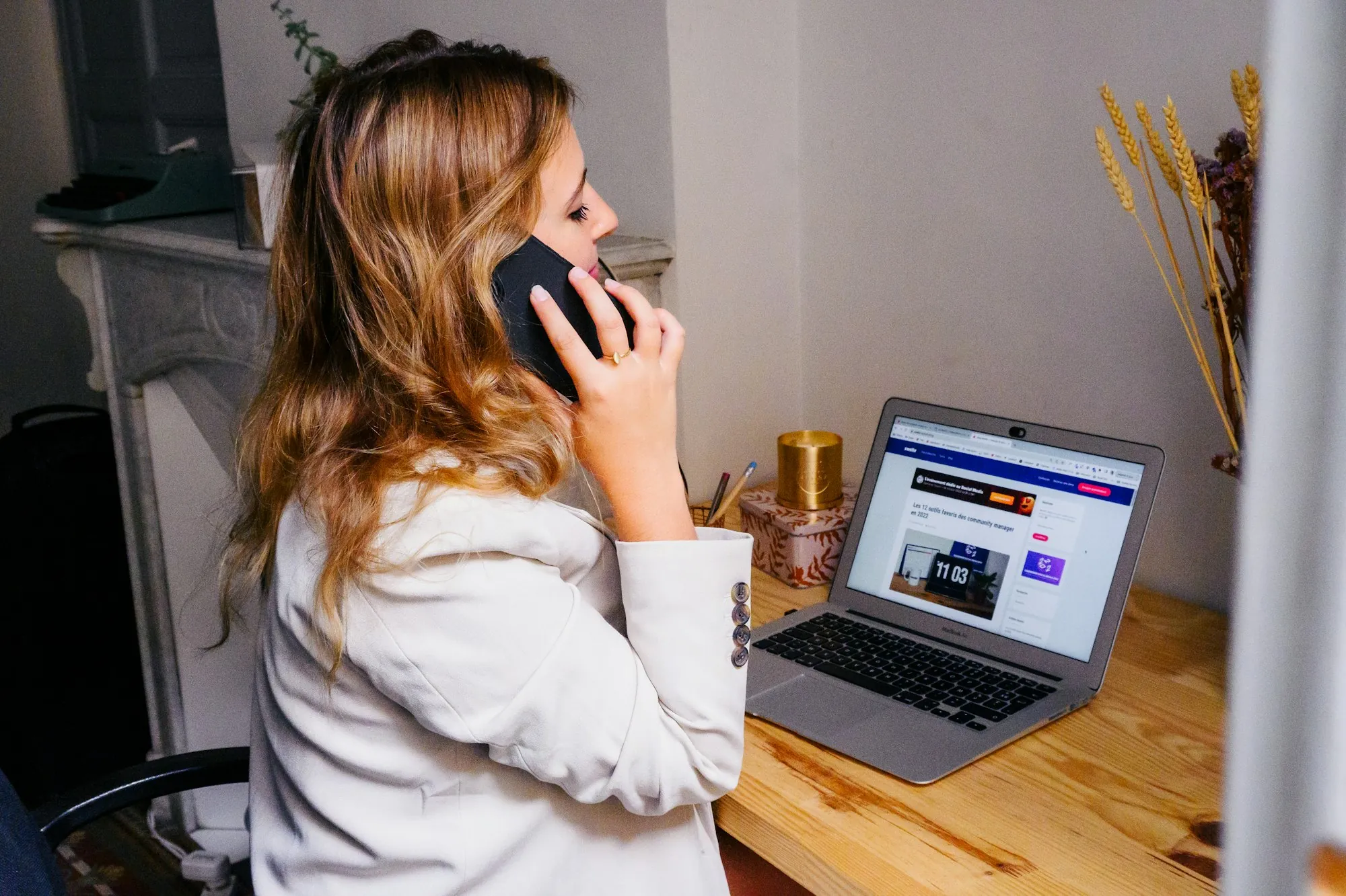 A woman at a desk with a telephone