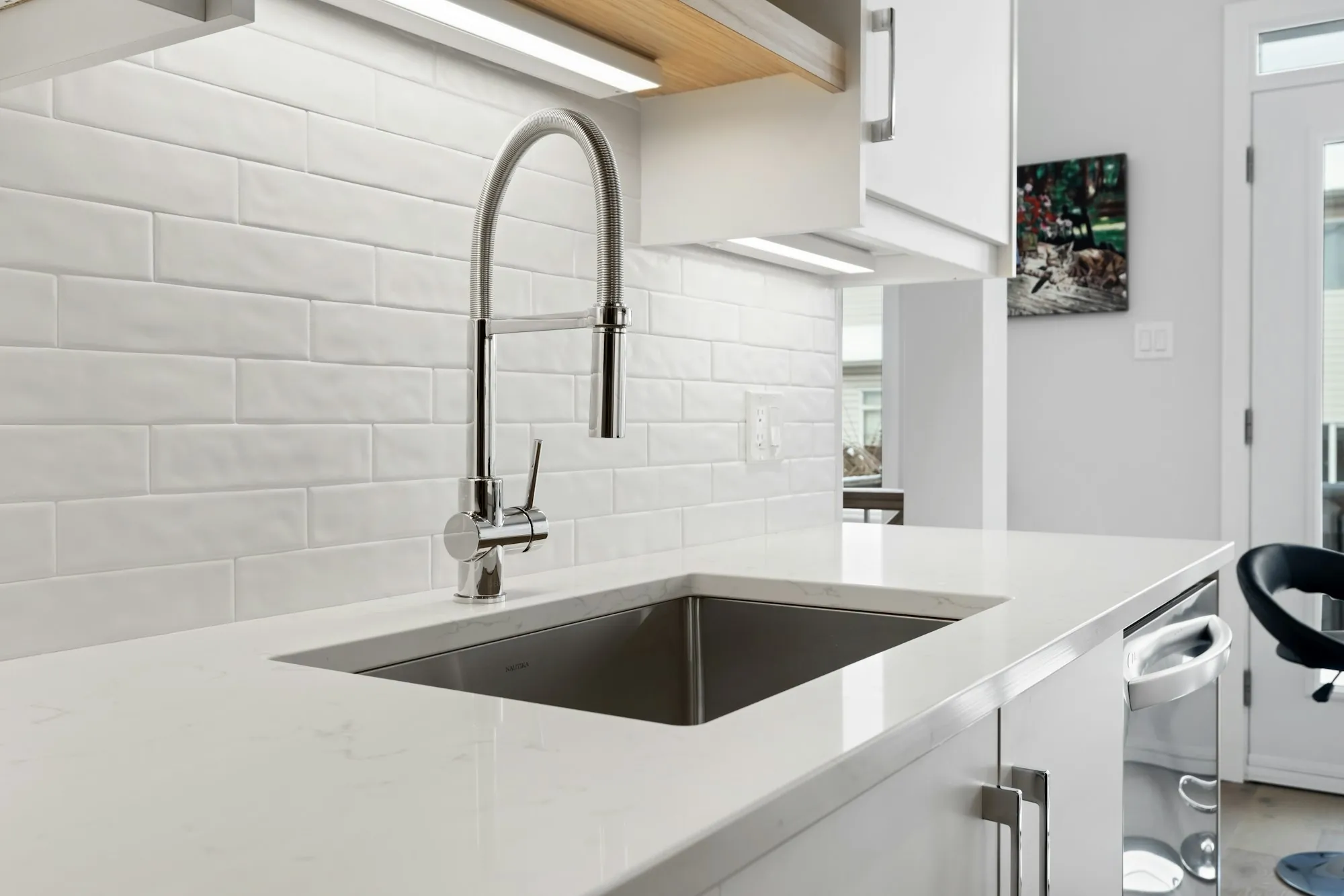 A kitchen with a sink beneath a window