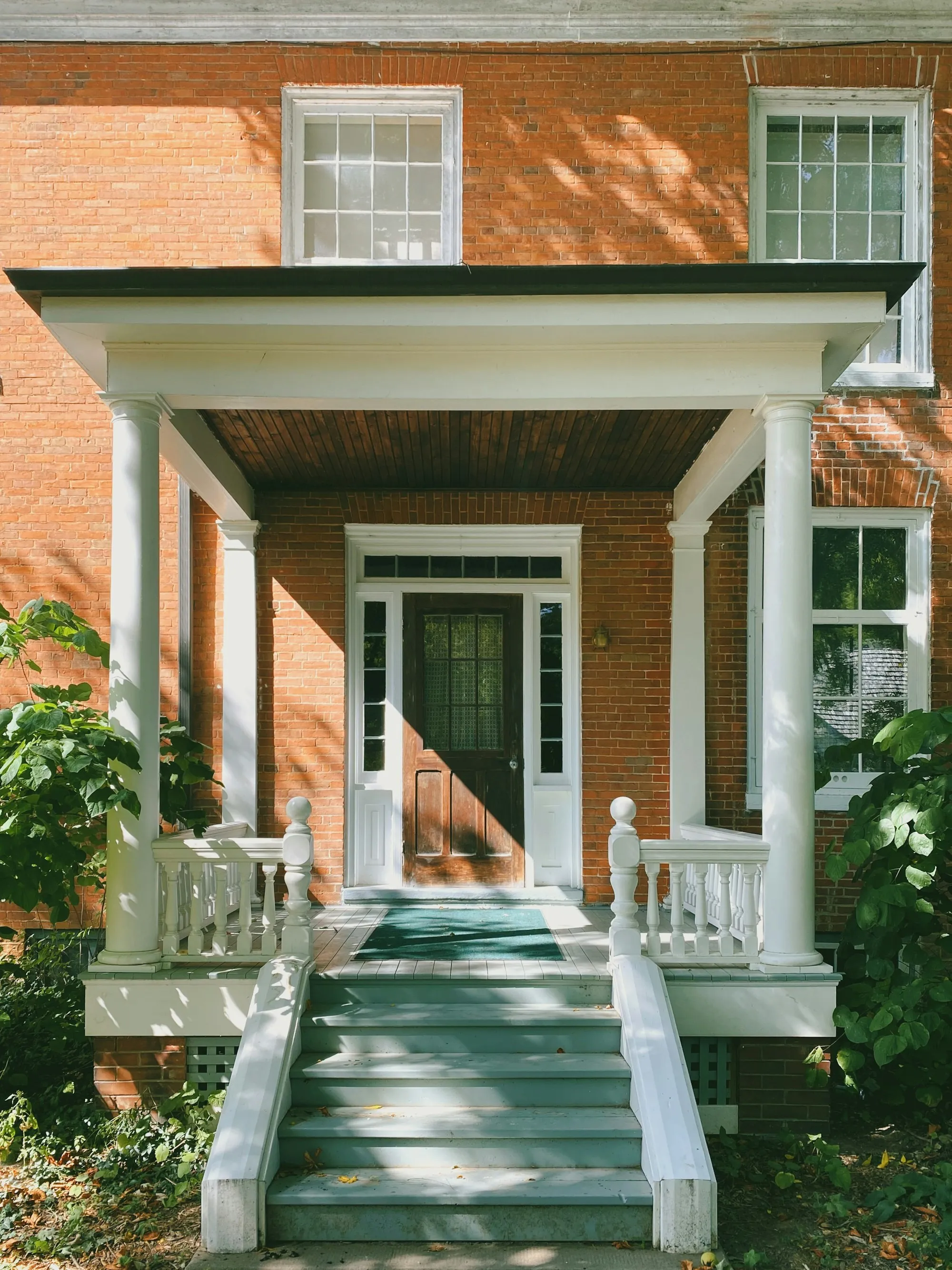 A brick house with a white wooden front door