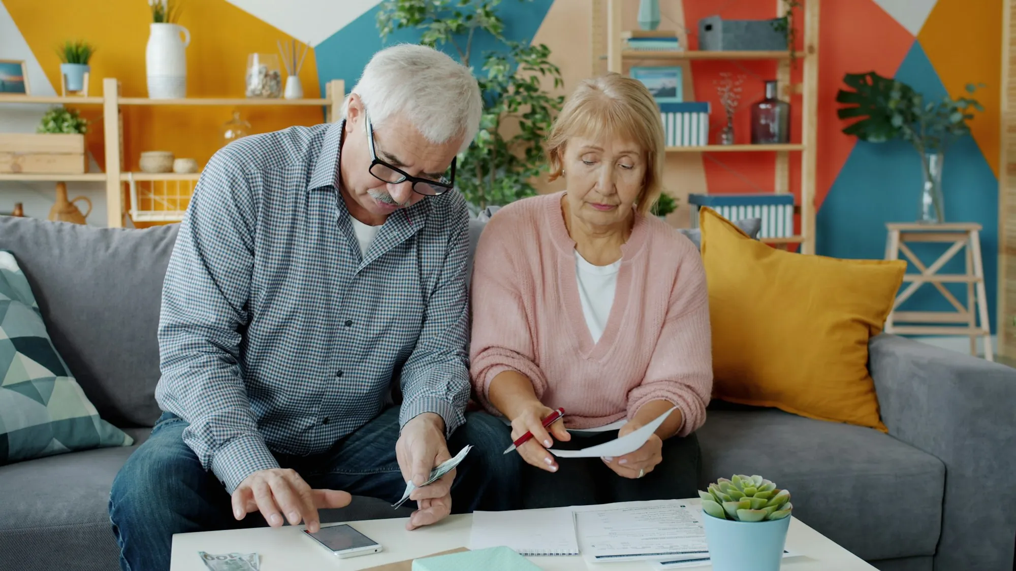 Two people at a table looking through papers
